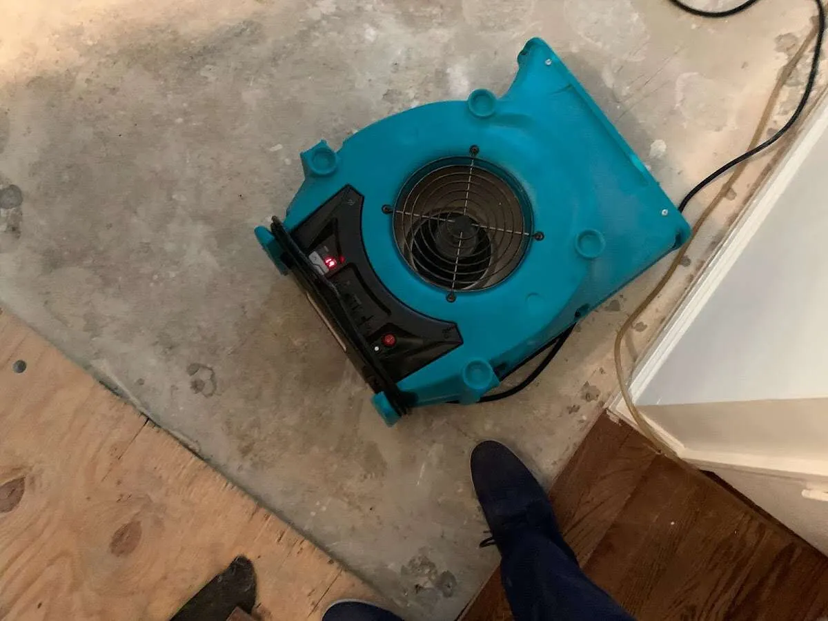 Air mover drying subfloor during Leak Detection & Repair in Washington Terrace